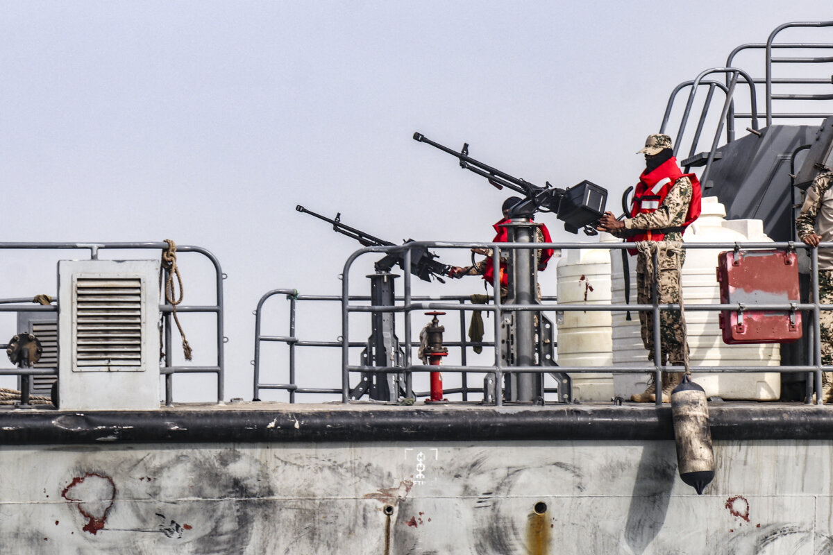 Sailors from the navy of Yemen's Aden-based internationally recognised government stand at machine-gun positions aboard a vessel patrolling a shipping lane off Hanish Island in the Red Sea on July 27, 2026. (Khaled Ziad / AFP via Getty Images)