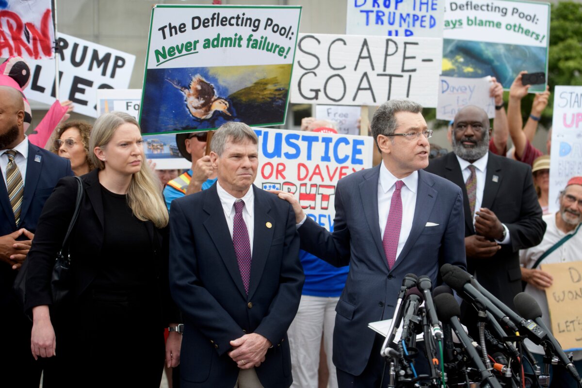 Former Olympic canoeist David Hearn (2nd L) listens as his attorney Norman Eisen (R) speaks after he pleaded not guilty to allegedly damaging the Lincoln Memorial Reflecting Pool in Washington on July 9, 2026. (Rod Lamkey, Jr./AP Photo)
