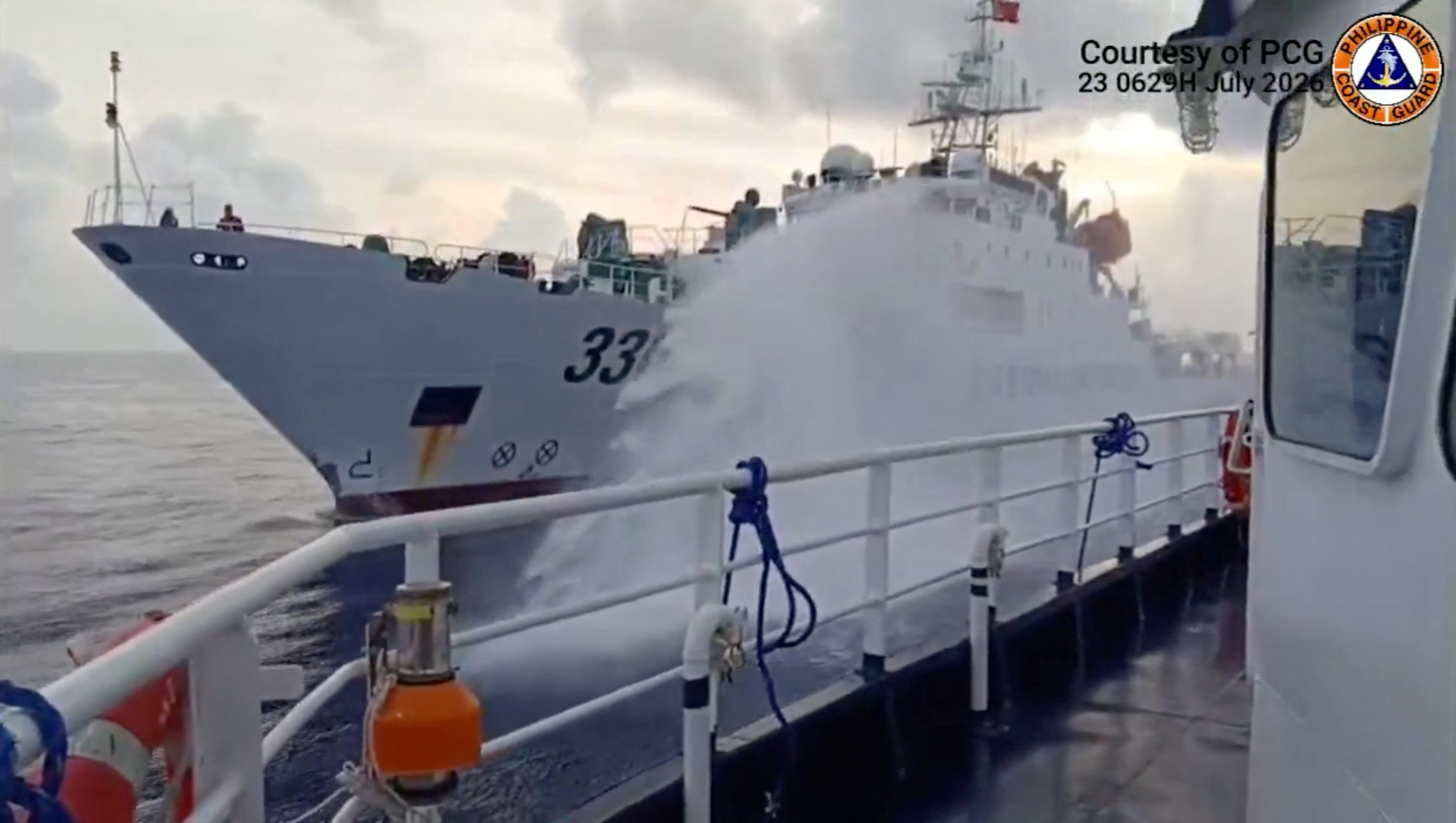 A Chinese coast guard ship fires a water cannon at a Philippine vessel