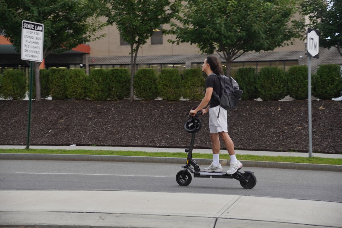An electric scooter rider on the road in Middletown, N.Y., on Aug. 8, 2026. (Oliver Mantyk/The Epoch Times)