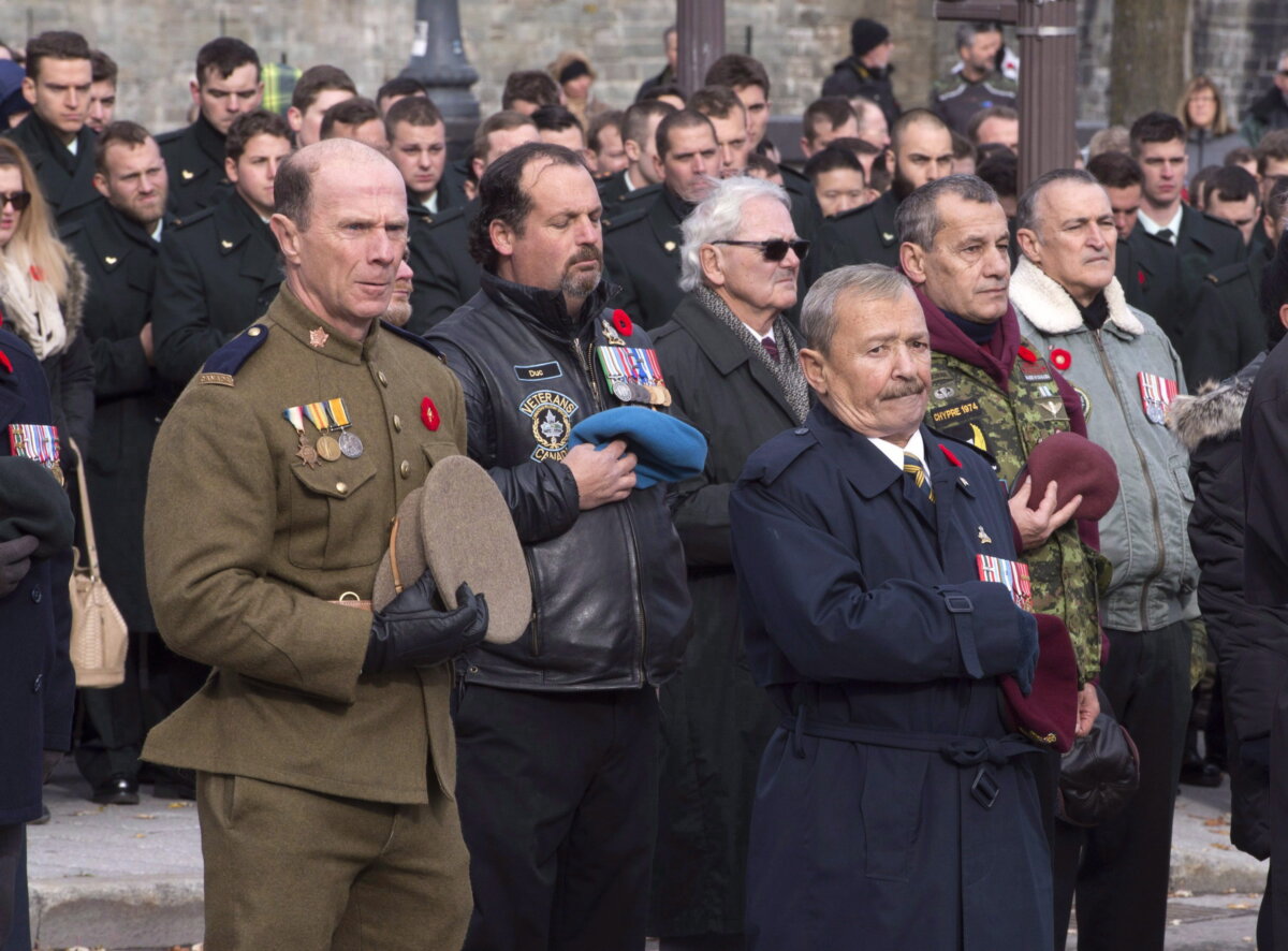 Veterans take their hat off during a prayer at a Remembrance Day ceremony in Quebec City on Nov. 11, 2016. (The Canadian Press/Jacques Boissinot)