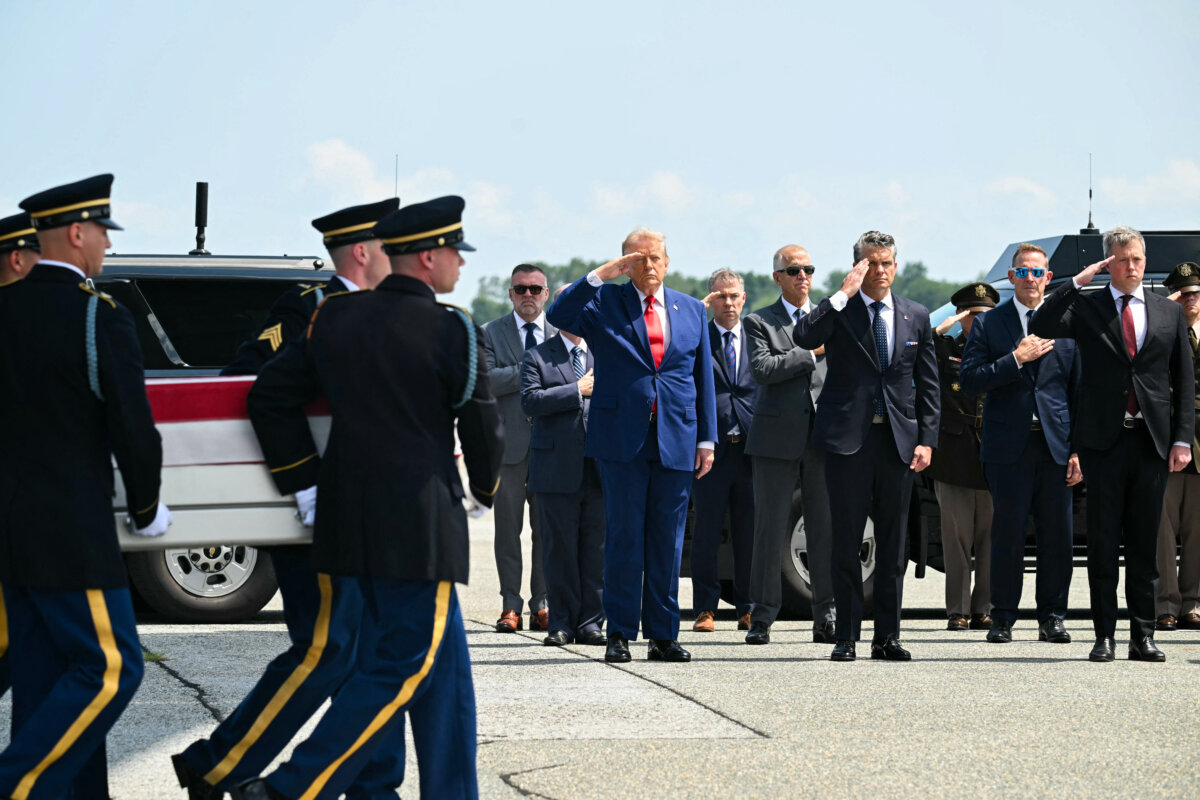 President Donald Trump salutes as a US Army carry team carries the flag-draped transfer case containing the remains of 1st Lt. Tyler James Feehan, during a dignified transfer solemn event for US service members killed during operations in the Middle East, at Dover Air Force Base in Dover, Del., on July 22, 2026. (SAUL LOEB / AFP via Getty Images)