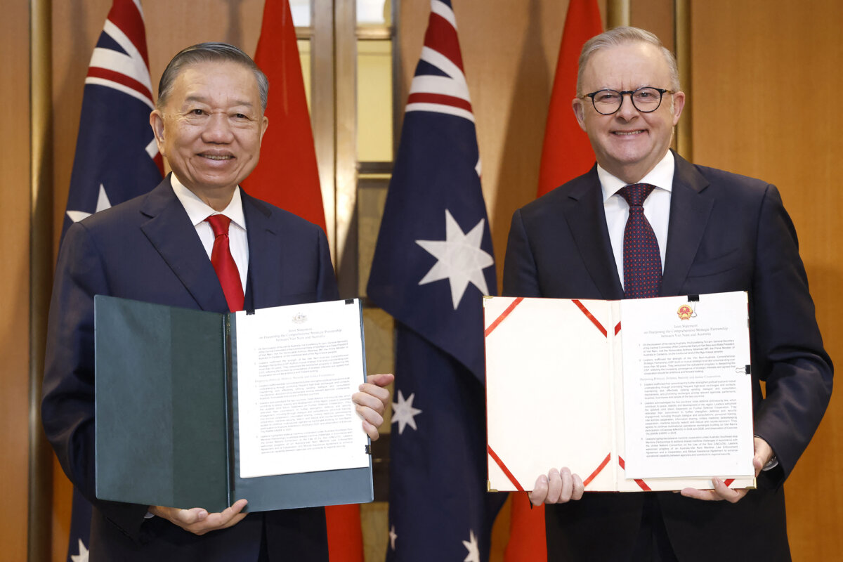 Australian Prime Minister Anthony Albanese (R) and Vietnam General Secretary and President To Lam exchange documents after a bilateral meeting at Parliament House in Canberra, Australia, on Aug. 11, 2026. (Hilary Wardhaugh/AFP via Getty Images)