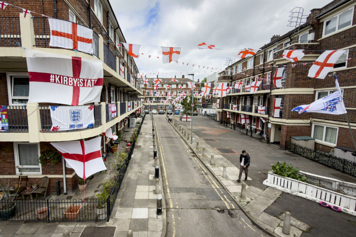 St George's Cross flags displayed on balconies and lampposts at the Kirby Estate in London, on June 12, 2026. (Leon Neal/Getty Images)
