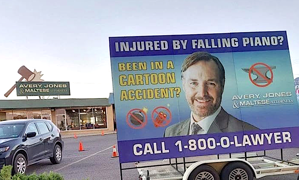 lawyer ad sits on trailer in parking lot in Coyote Vs. ACME