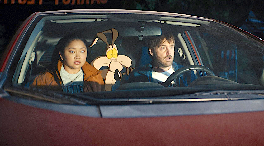 one woman, a cartoon coyogte, and a man, in a maroon car, in Coyote Vs. ACME