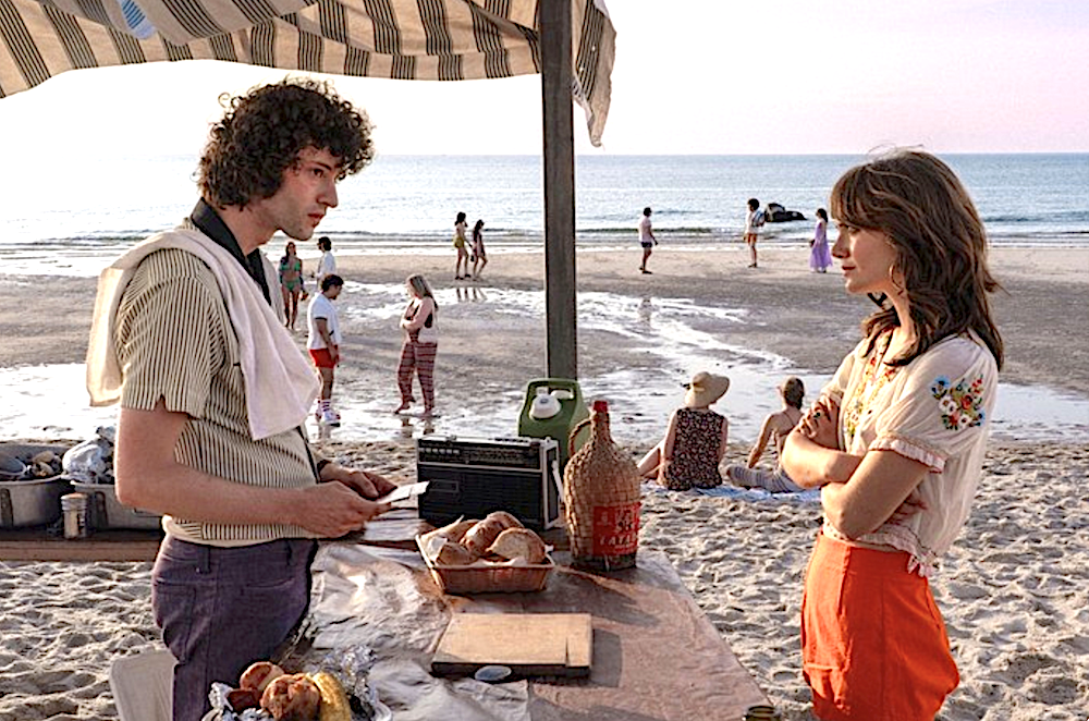 man and woman talk on the beach in Tony