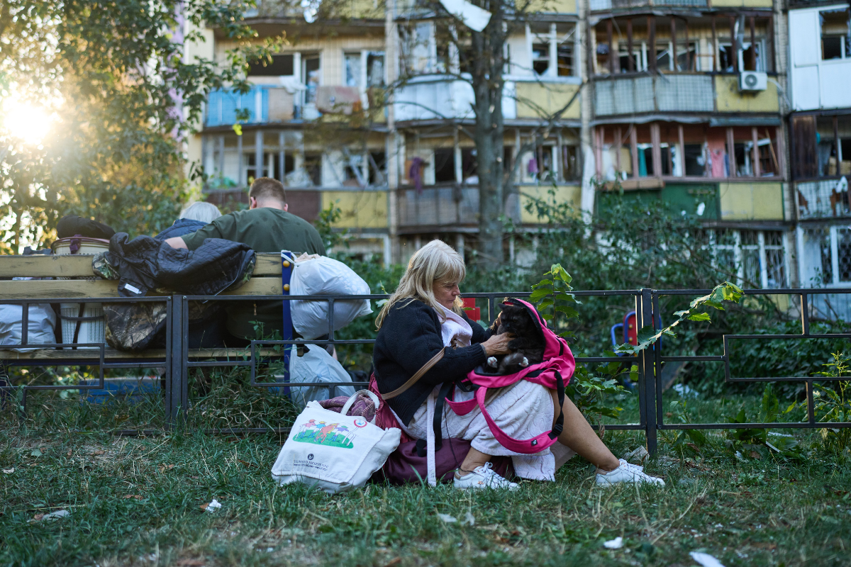 Residents sit in front of heavily damaged residential buildings after an overnight Russian attack, in Kyiv, Ukraine, on Aug. 20, 2026. (Francisco Seco/AP Photo)