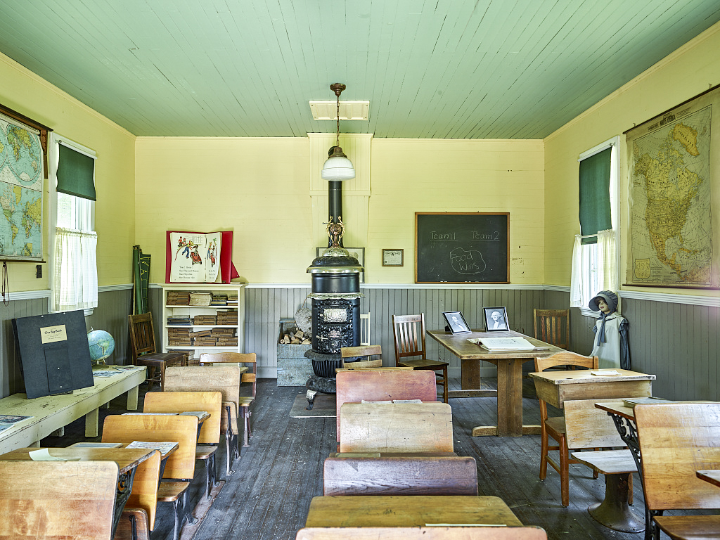 Classroom of the Clutterville one-room schoolhouse, part of the Ackley Heritage Center that also includes a pioneer home and, in town, an old-fashioned soda fountain, barber shop, and beauty parlor in Ackley, Iowa. The school was typical of those located every two miles or so throughout the countryside. It was built around 1907 in Butler County and relocated to the Ackley site.