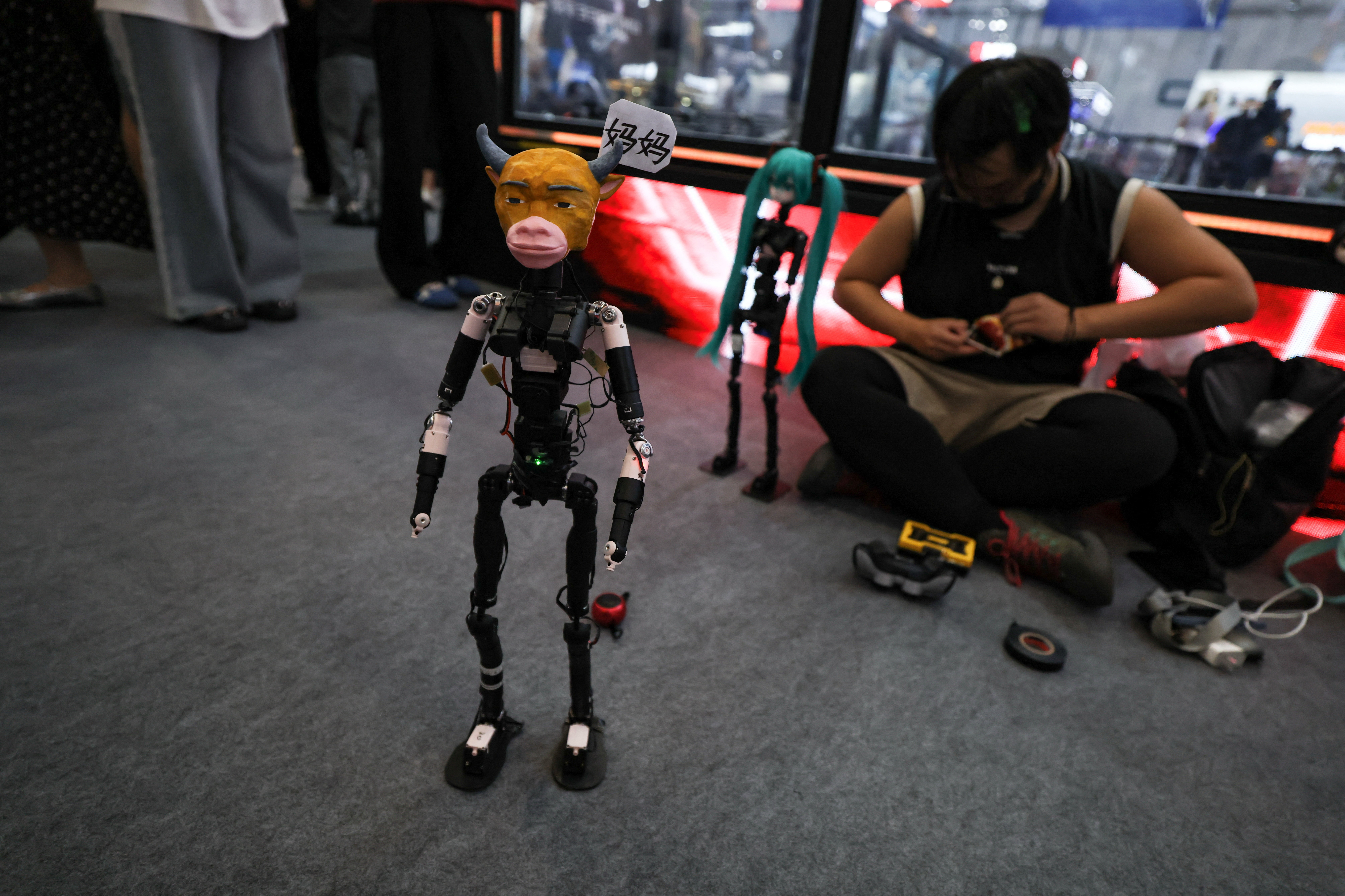 Robot with the head of Niu Lai, a character from a Chinese animated film Niu Lai, stands during the 2026 World Robot Conference in Beijing