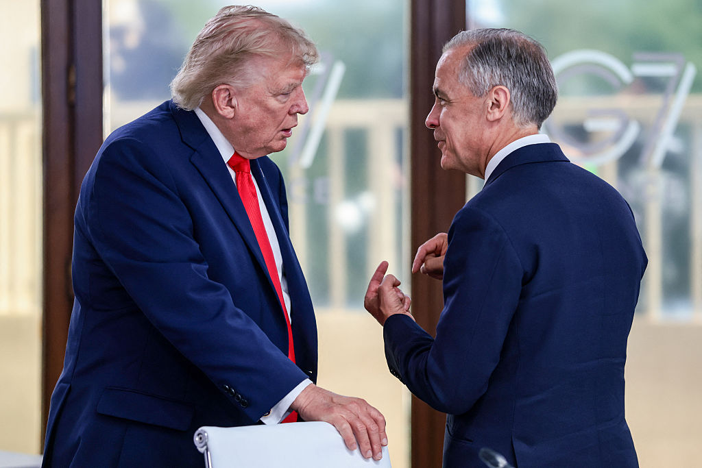 U.S. President Donald Trump speaks with Canadian Prime Minister Mark Carney during a work lunch as part of the G7 summit, in Evian, France, on June 16, 2026. (Evelyn Hockstein/POOL/AFP via Getty Images)