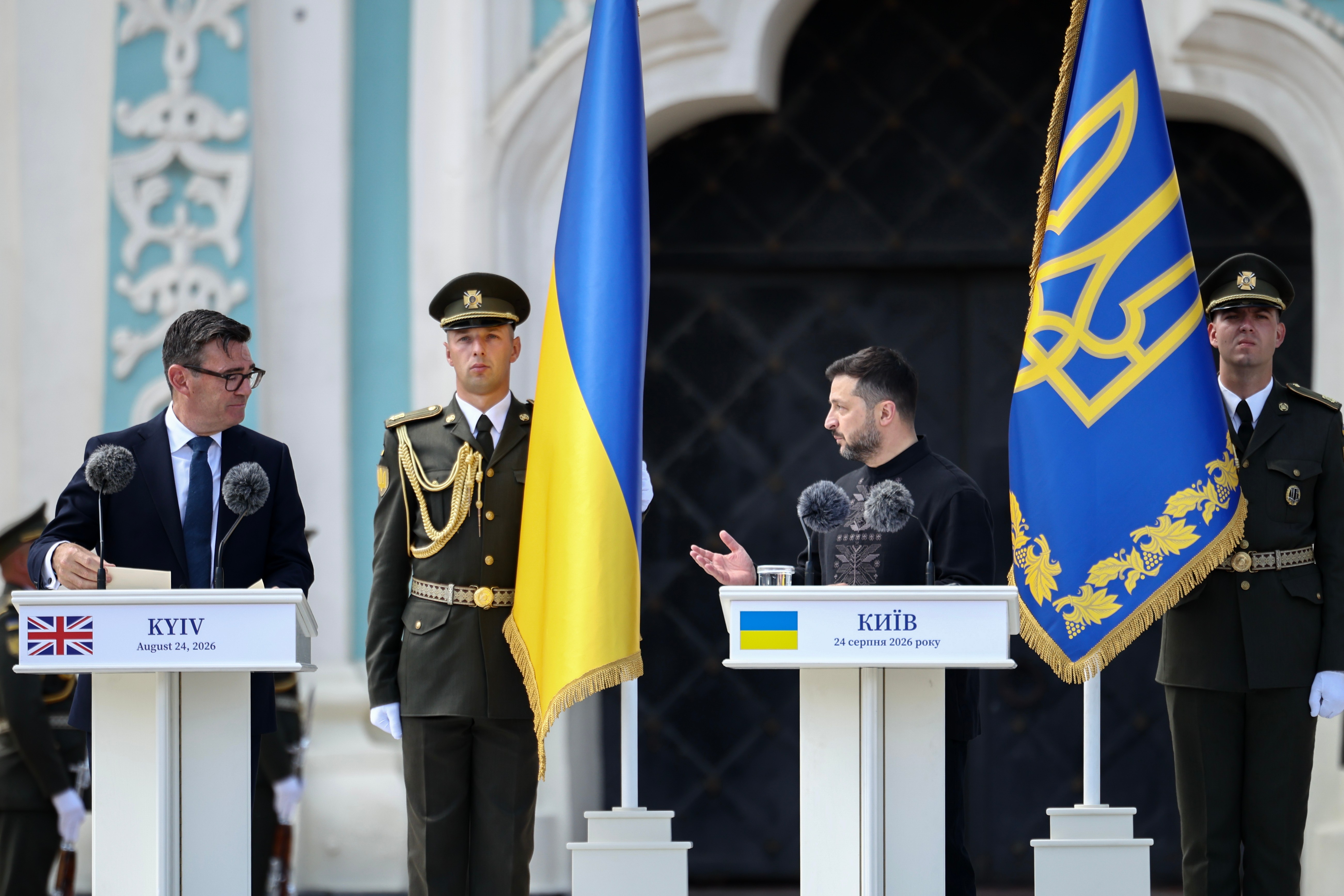 Премьер-министр Великобритании Энди Бернхэм (слева) смотрит на президента Украины Владимира Зеленского (справа) во время его выступления на церемонии, посвященной 35-летию независимости Украины, у Софийского собора в Киеве, Украина, 24 августа 2026 года. (Фото Генри Николлса/Pool Photo via AP)
