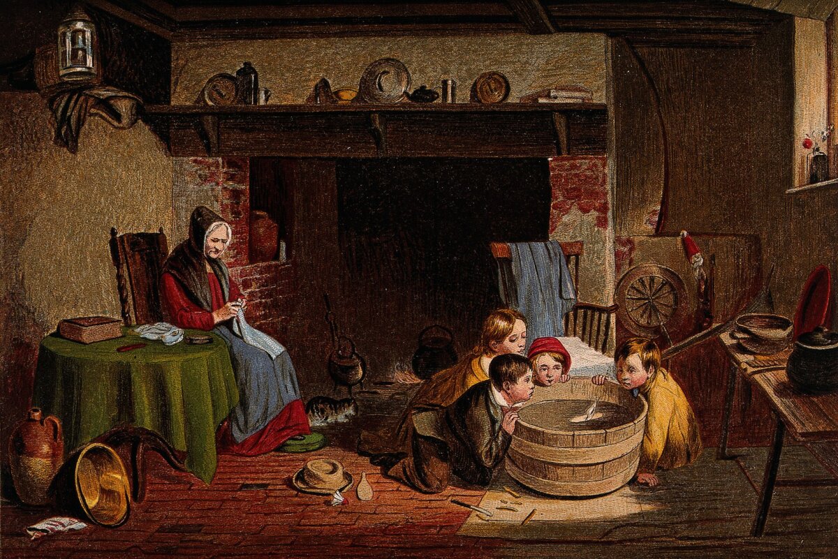 A family scene in a kitchen with an old woman sitting by children. (Fæ/CC BY 4.0)