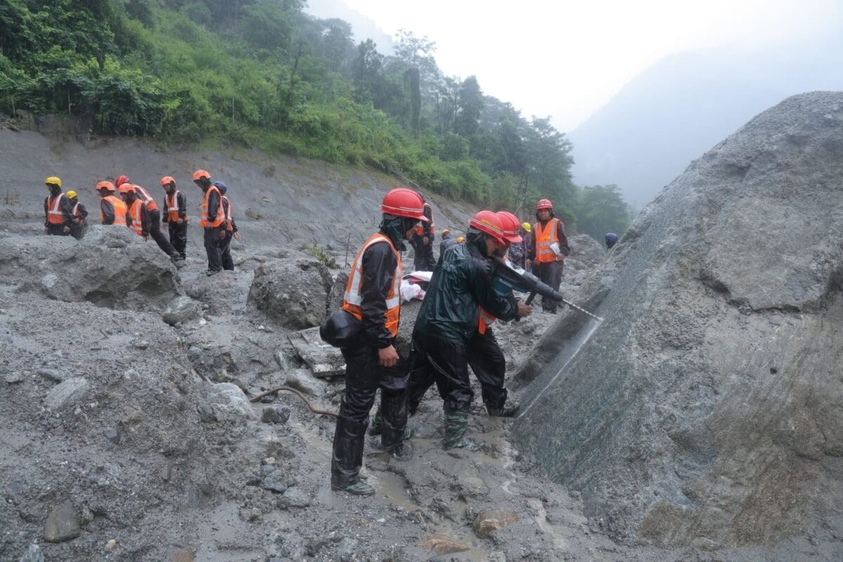 Rescue workers clear mud and debris near the entrance of a tunnel at the Trishuli 3A Hydropower Project in Rasuwa, Nepal, as efforts continue to reach people trapped inside. (Courtesy of Nepal’s Prime Minister’s Office)