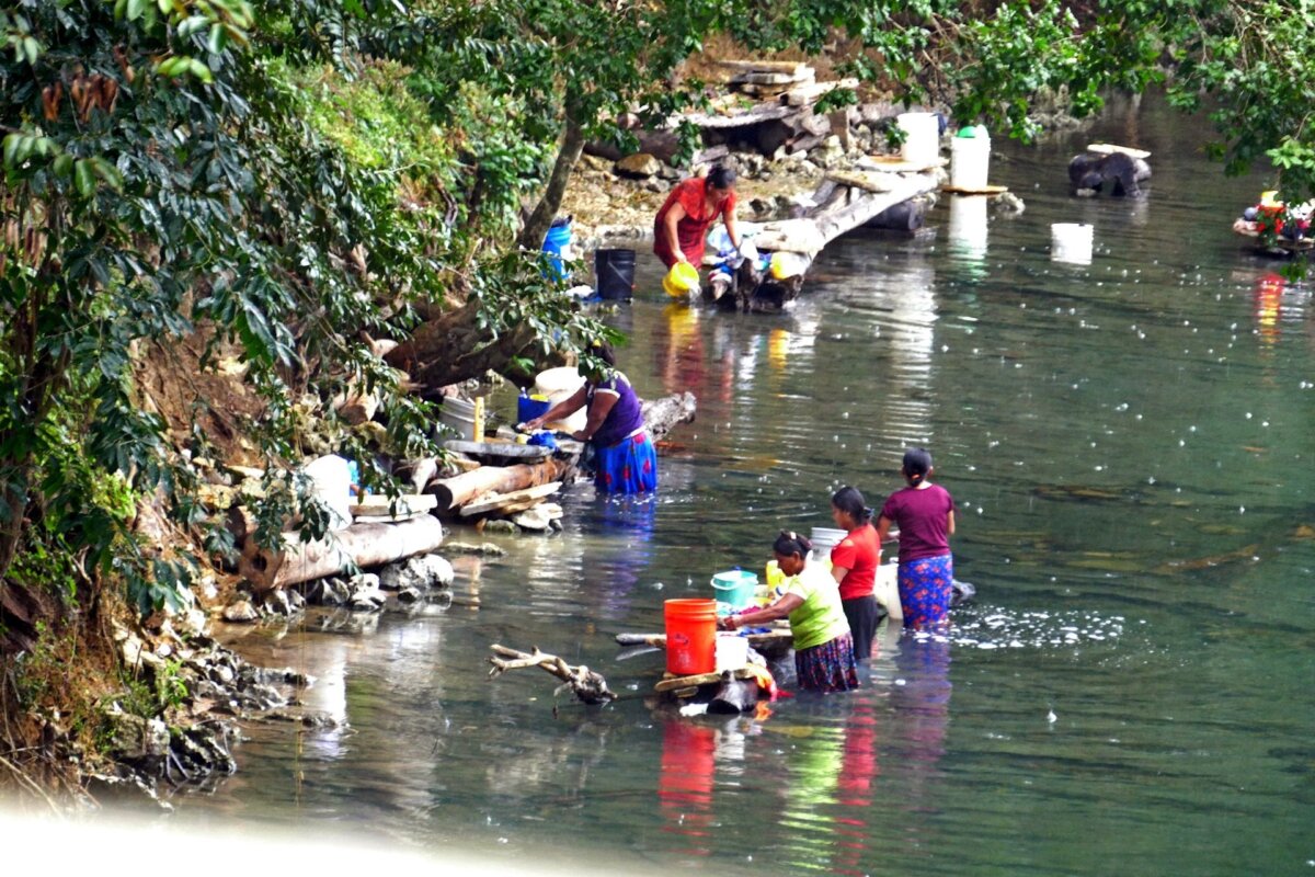 Maya women do their laundry in a river near Placencia in Belize.
(Photo courtesy of Phil Allen)