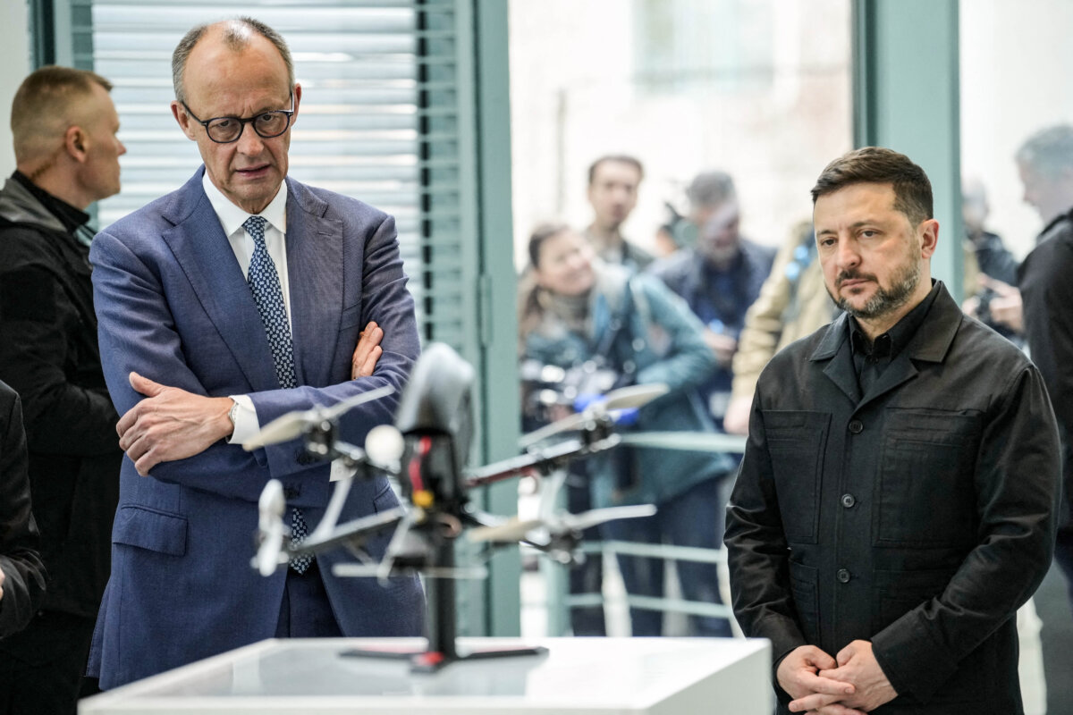 German Chancellor Friedrich Merz (L) and Ukrainian President Volodymyr Zelensky watch a presentation of drones made in German-Ukrainian cooperation during a visit at the Chancellery in Berlin on April 14, 2026 prior to German-Ukrainian government consultations. The meeting comes as US-initiated peace talks between Russia and Ukraine have stalled, with Kyiv baulking at the idea it could cede territory to Russia. (Photo by Ebrahim Noroozi / POOL / AFP via Getty Images)