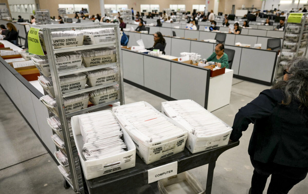 An election worker moves mail-in ballots to be organized for tabulation in Calif., on June 2, 2026. (Patrick T. Fallon / AFP via Getty Images)