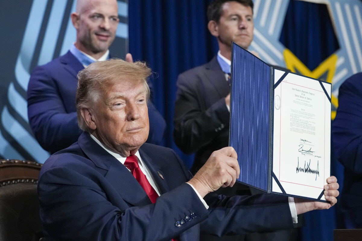 President Donald Trump holds up the Hershel "Woody" Williams National Medal of Honor Monument Location Act after signing it during an event at the National Medal of Honor Museum in Arlington, Texas, on September 10, 2026. (Andrew Harnik/Getty Images)