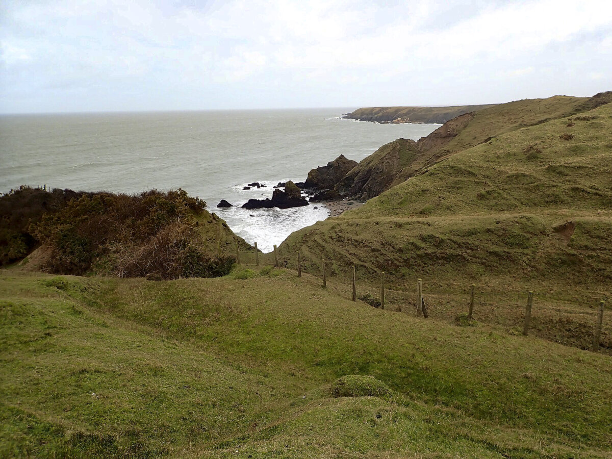 This spot on the Welsh Coast Path looks out on the rocky waters edge and Irish Sea, where Edward King lost his life centuries ago. (Eirian Evans/CC BY-SA 2.0)