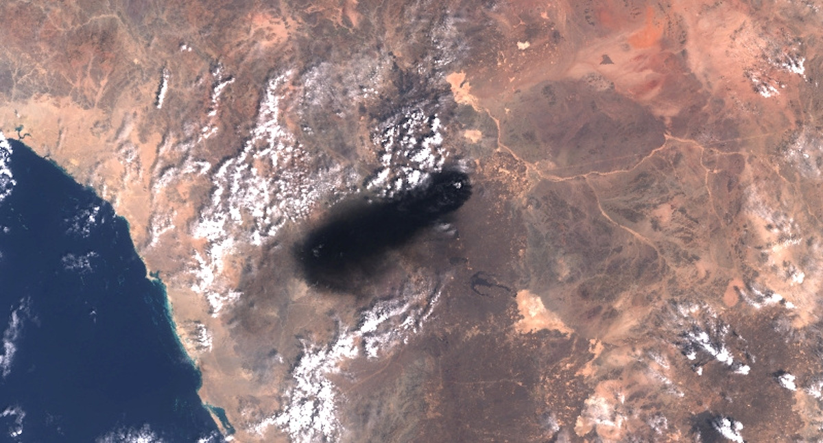 A satellite image shows black smoke rising from an area of Saudi Arabia’s East-West oil pipeline south of Medina
