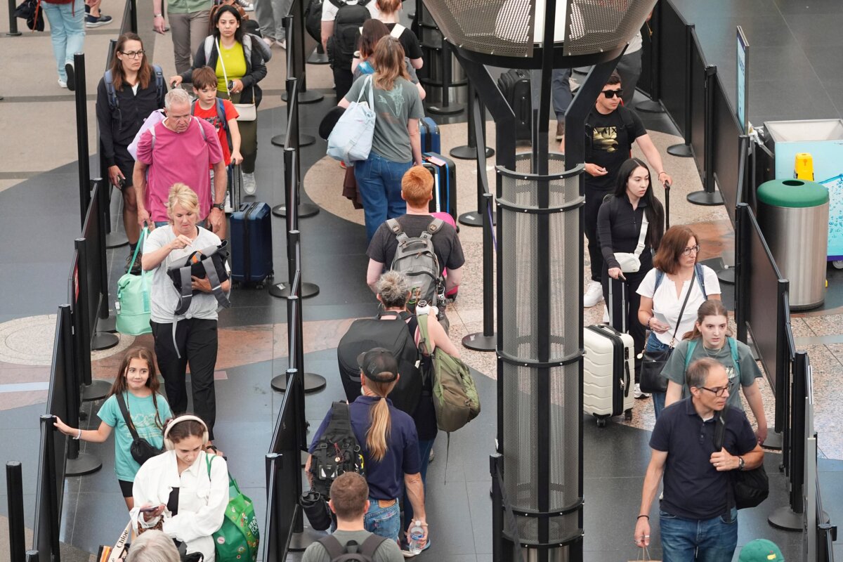 Travelers queue up to pass through the south security checkpoint in Denver International Airport on July 2, 2025. (David Zalubowski/AP)