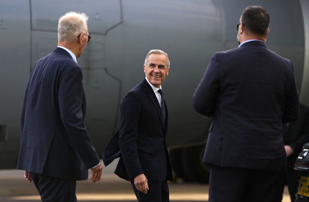 Prime Minister Mark Carney speaks with High Commissioner for Canada in the United Kingdom Bill Blair, left, as he arrives in Manchester, England, on Sept. 16, 2026. (The Canadian Press/Justin Tang)