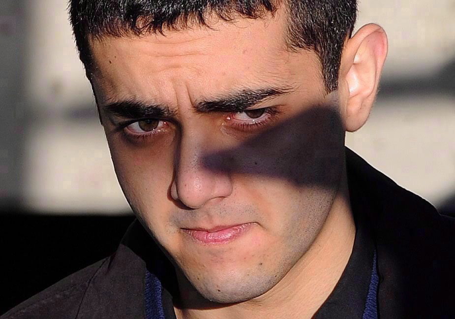 Hamed Mohammed Shafia is escorted by police officers into the Frontenac County courthouse in Kingston, Ont., on Jan. 18, 2012. (The Canadian Press/Sean Kilpatrick)