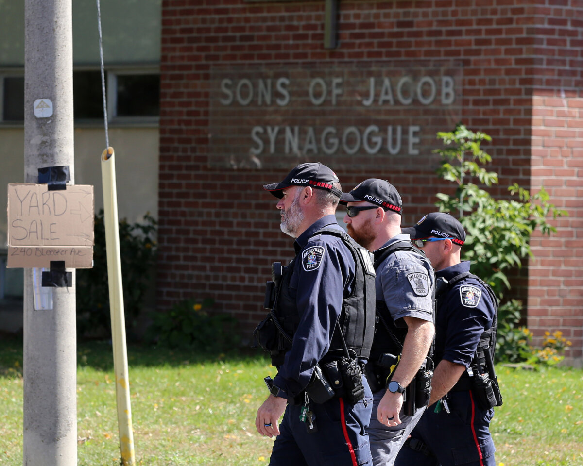 Police officers walk in front of the Son of Jacob Synagogue in Belleville, Ont., on Sept. 21, 2026. (The Canadian Press/Ian MacAlpine)