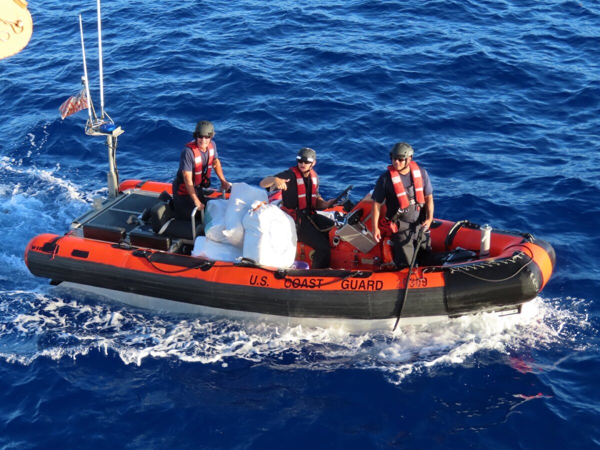 A Coast Guard Cutter Escanaba (WMEC 907) small boat crew transfers seized narcotics to the cutter while underway off Haiti, on Aug. 29, 2026. Escanaba’s crew and additional Coast Guard units recovered 2,082 pounds of marijuana during the interdiction. (Courtesy of the US Coast Guard)