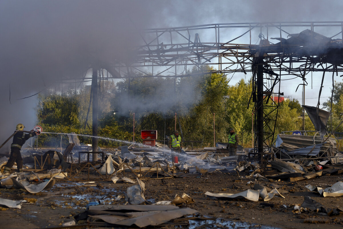 A firefighter and police officers work at the site of a petrol station hit by a morning Russian drone strike, amid Russia's attack on Ukraine, in Kyiv, Ukraine, on Sept. 23, 2026. (Valentyn Ogirenko/Reuters)