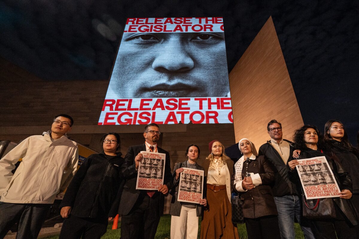 The faces and names of some political prisoners held in China are projected on the National Gallery of Art, as Chinese leader Xi Jinping participates in a state visit to Washington on Sept. 23, 2026. (Samira Bouaou/The Epoch Times)