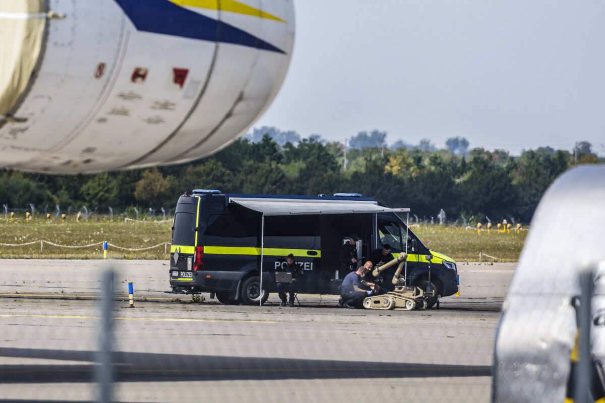 Police investigators work on the tarmac with a robot that is capable of defusing explosives, near to Ukrainian Antonov cargo plane at Leipzig/Halle Airport, in Germany, on August 5, 2026. (Jens Schlueter/Getty Images)
