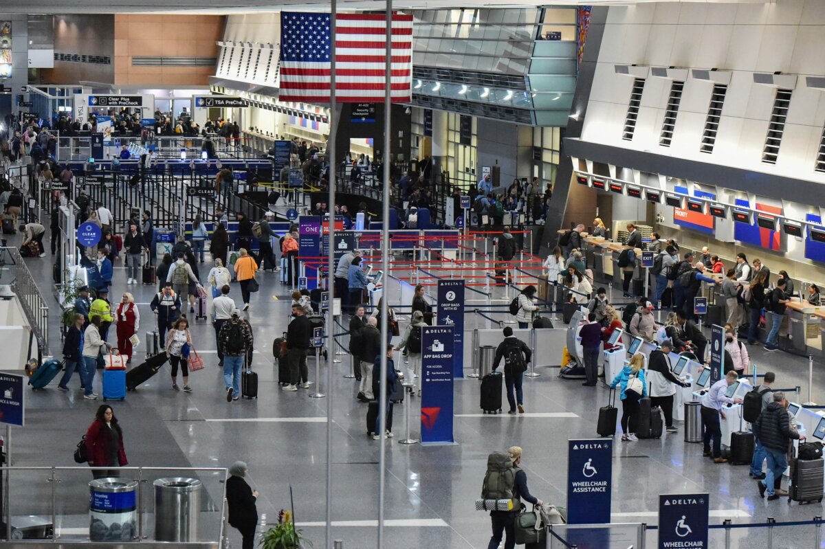 Travelers check in for flights at Boston Logan International Airport in Boston on Nov. 10, 2025. (Joseph Prezioso/AFP via Getty Images)