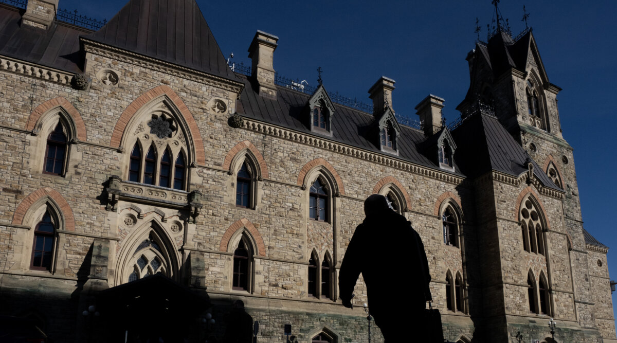 A person is silhouetted against West Block as Parliament returns following the summer recess in Ottawa, on Sept. 21, 2026. (The Canadian Press/Adrian Wyld)