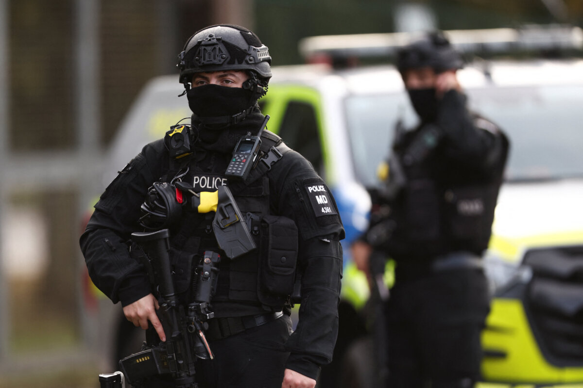 An armed police officer stands guard on a road outside the perimeter of the RAF Fairford airbase, in Fairford, England, on Sept. 28, 2026. (Toby Shepheard/Reuters)