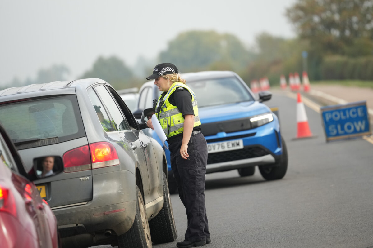 Police officers stand at a checkpoint near RAF Fairford air base, in Fairford, England, on Sept. 29, 2026. (AP Photo/Alastair Grant)