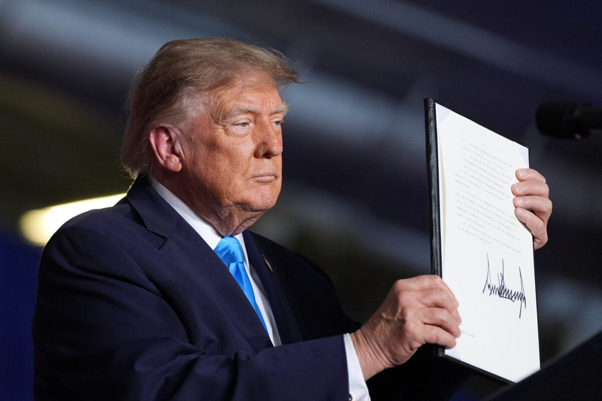 President Donald Trump displays a signed executive order at a campaign rally at the Pinnacle Bank Expo Center in Grand Island, Neb., on Oct. 5, 2026. (Alex Brandon/AP Photo)