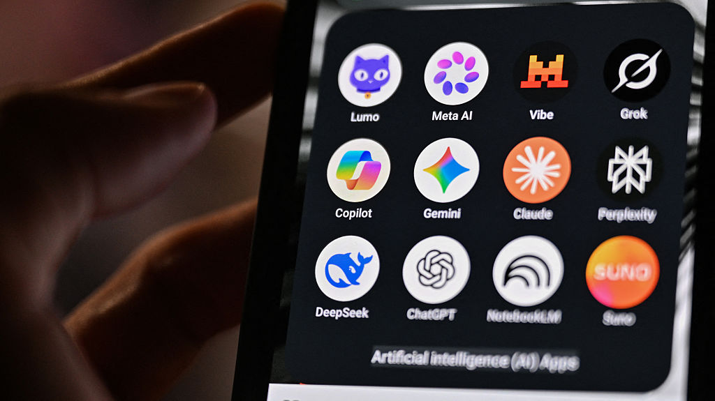 This photograph shows a handheld smartphone displaying the icons of some of the main artificial intelligence based apps, including LLMs, chatbots and generative AI, with logos (from L) of Proton AG's Lumo, Meta AI, Mistral Vibe (formerly Le Chat), xAI's Grok, Microsoft's Copilot, Google's Gemini, Anthropic's Claude, Perplexity, Deepseek, OpenAI's Chat GPT, Google's Notebook LLM and generative AI music app Suno, in Saint-Mande, east of Paris, France on July 15, 2026. (Martin Lelievre/ AFP via Getty Images)