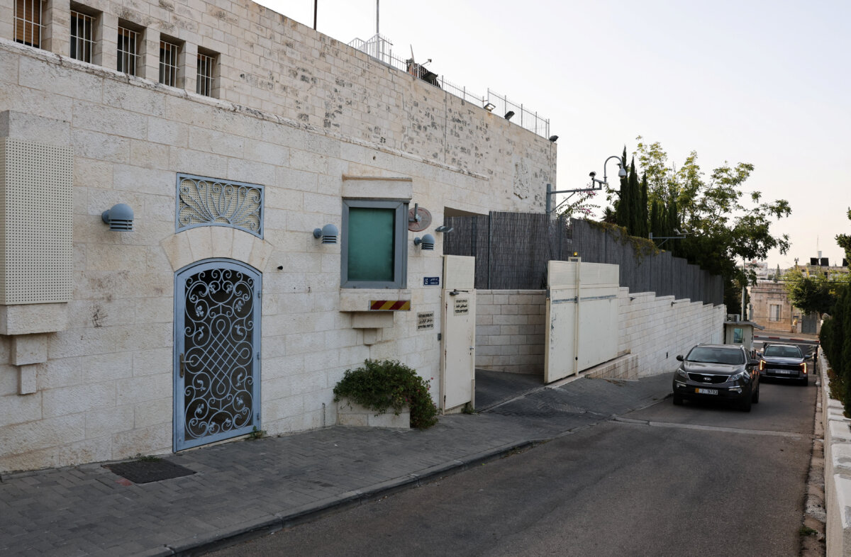 Vehicles approach the British consulate with signage removed near the entrance, on the deadline set by Israel for its closure, following trade sanctions imposed by British Prime Minister Andy Burnham on Israeli settlements in the occupied West Bank, in East Jerusalem on Oct. 8, 2026. (Ammar Awad/Reuters)