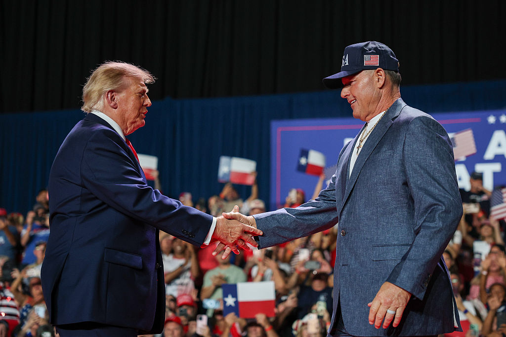 President Donald Trump (L) shakes hands with former MLB player Roger Clemens after he was introduced during a campaign rally at the Freeman Coliseum in San Antonio, Texas, on Oct. 7, 2026. (Win McNamee/Getty Images)