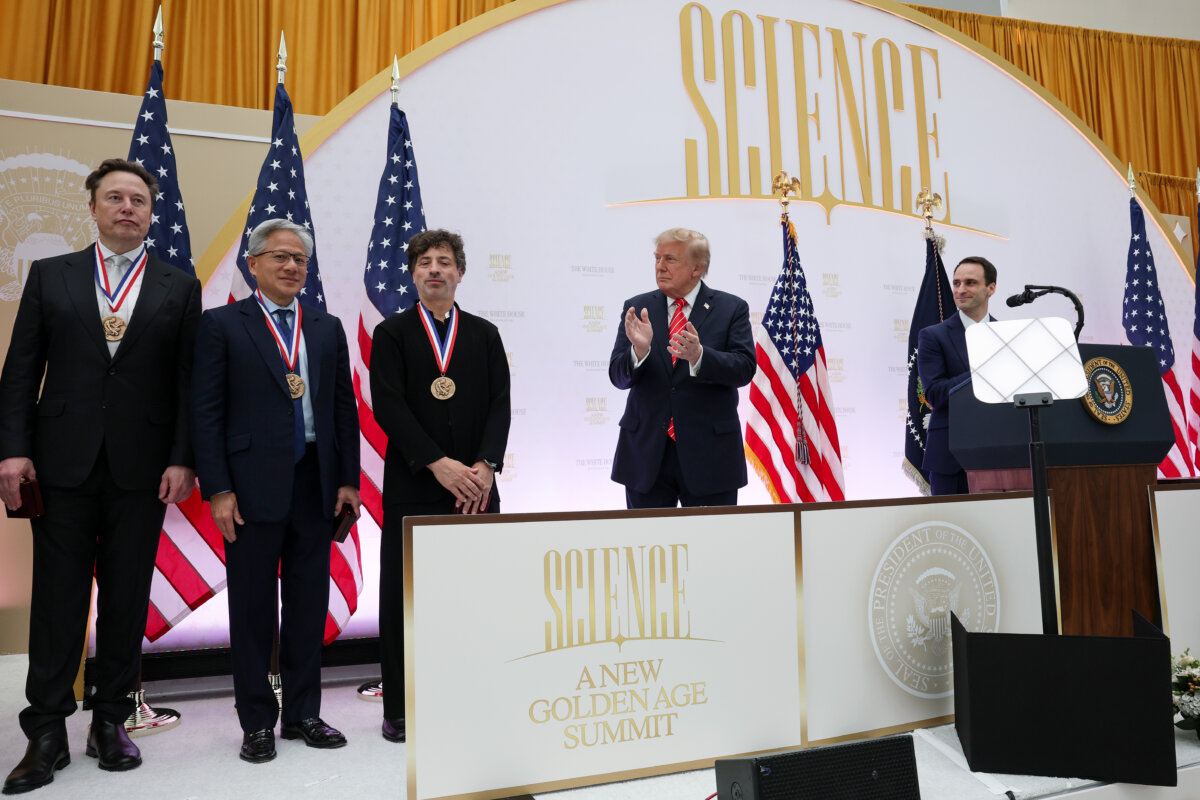 President Donald Trump stands on stage with (L–R) Tesla and SpaceX CEO Elon Musk, Nvidia CEO Jensen Huang, and co-founder of Google and former President of Alphabet Sergey Brin after awarding them medals during the Golden Age of American Innovation Summit at the Institute of Peace in Washington on Oct. 8, 2026. (Win McNamee/Getty Images)
