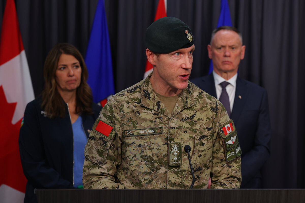 Maj.-Gen. Wade Rutland speaks as National Defence Minister David McGuinty and Alberta Premier Danielle Smith listen during a press conference in Edmonton on Oct. 18, 2026. (The Canadian Press/James Maclennan)