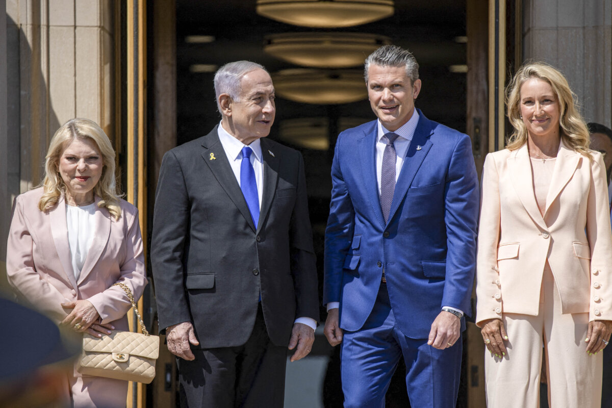 Secretary of Defense Pete Hegseth (R2) and his wife, Jennifer Rauchet (R9), Israeli Prime Minister Benjamin Netanyahu (L2), and his wife, Sara (L), during an arrival ceremony at the Pentagon in Washington, on July 9, 2025. (Mehmet Eser / Middle East Images via Getty Images)