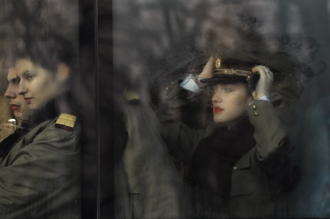 Romanian military doctors and medical students sit on a bus before the National Day parade in Bucharest, Romania, on Dec. 1. Military planes and helicopters flew over the Romanian capital Thursday as thousands turned out to celebrate the national day, marking the date when the country reunified with Transylvania in 1918. (AP Photo/Vadim Ghirda)