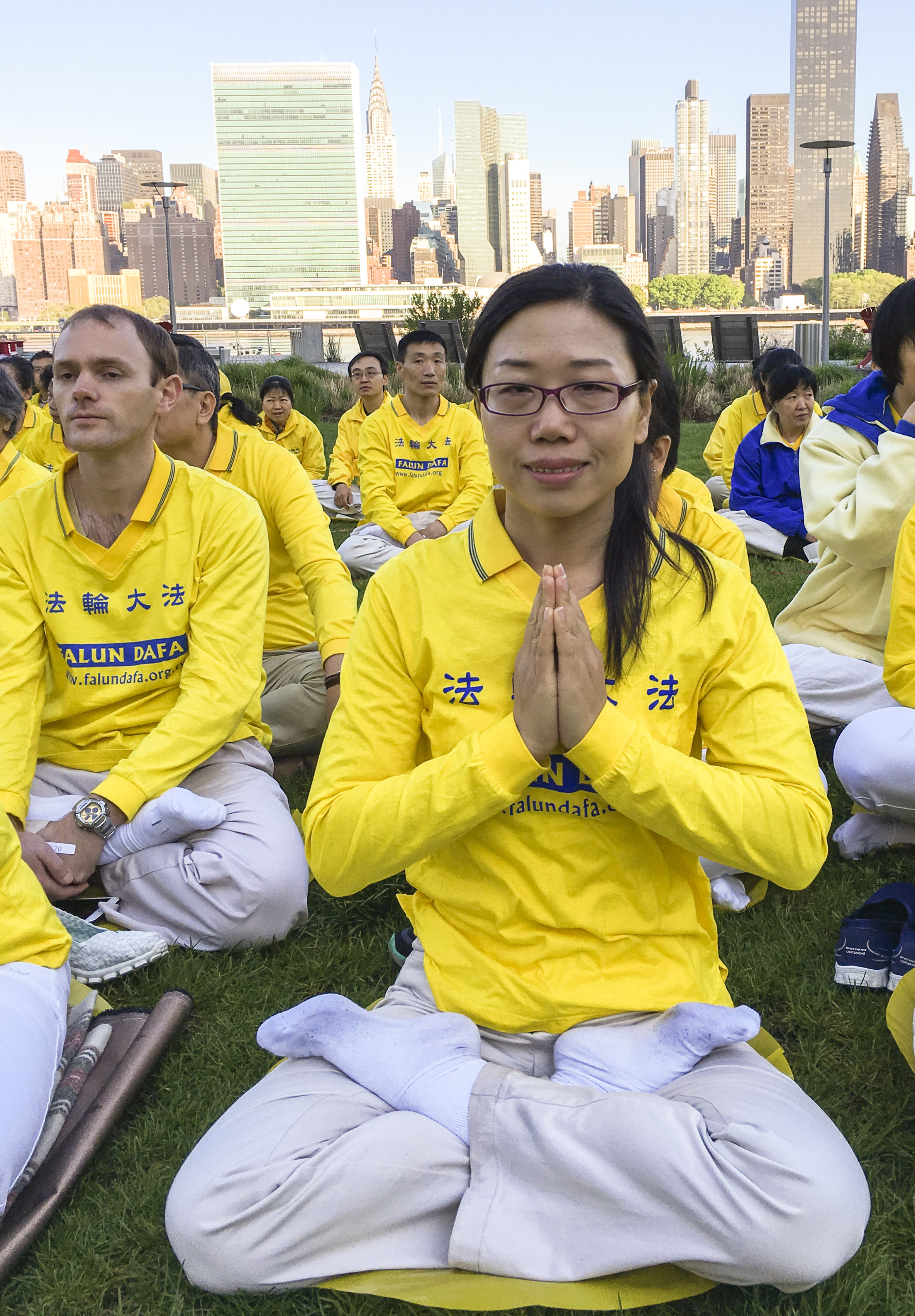 Li Lingling, a Falun Gong practitioner from Shandong Province, joins a character formation event at Gantry Plaza State Park on May 12, 2016. (Larry Ong/Epoch Times)