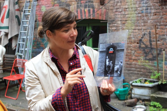 Stefanie Hempel, who does musical tours of St. Pauli, holds a picture of John Lennon. The Beatles got their start in Hamburg. (Wibke Carter)