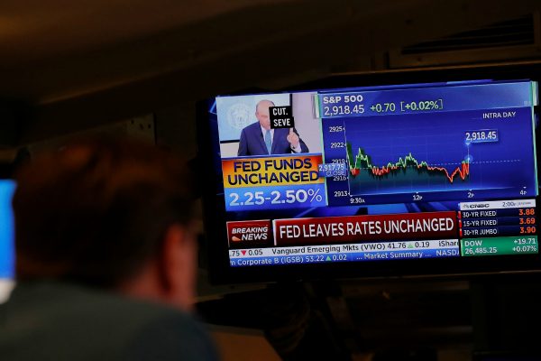 A trader looks at a screen at the New York Stock Exchange