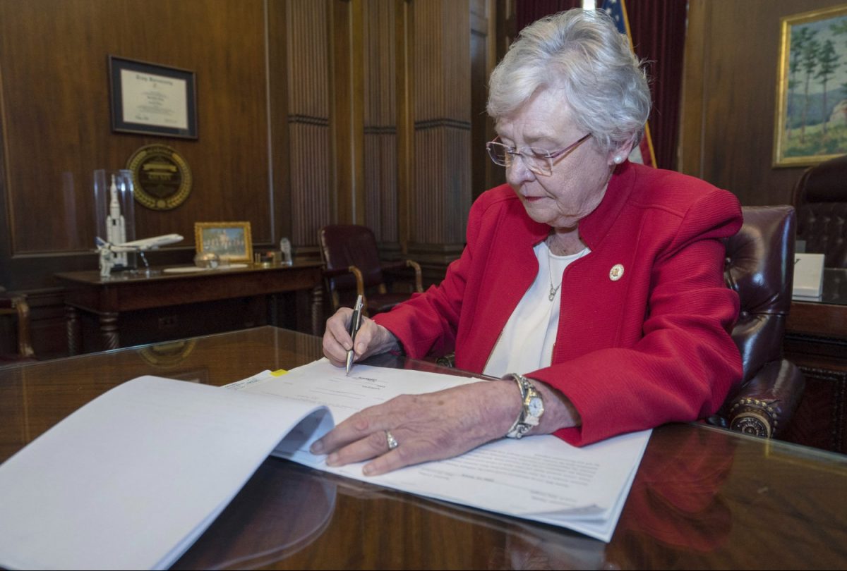 Alabama Gov. Kay Ivey signing a bill