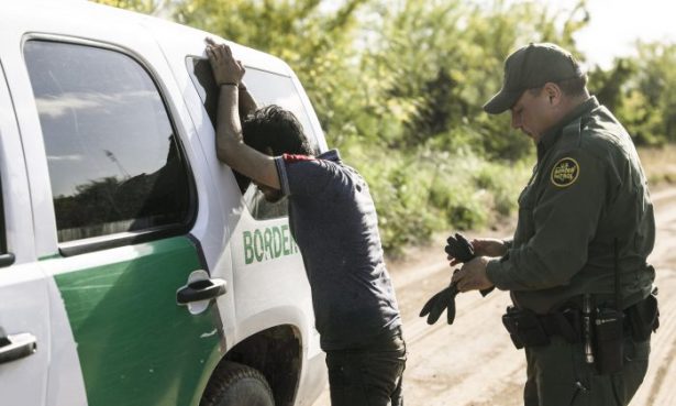 A Border Patrol agent prepares to search an illegal alien