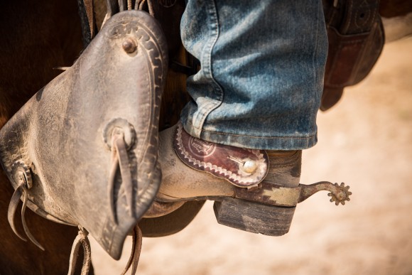 A boot and spur in a stirrup shows the Border Patrol logo. The stirrups and breast collars are made by Colorado Correctional Institute. (Benjamin Chasteen/The Epoch Times)